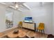 Open-concept living room boasts wood-look floors, a tv, and a view into the dining area at 671 47Th St, Sarasota, FL 34234