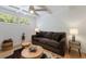 Comfortable living room with beamed ceilings, a ceiling fan, and plenty of natural light from the window at 671 47Th St, Sarasota, FL 34234