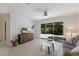 Inviting living room with terrazzo floors, a stylish media cabinet, and access to the outdoor area at 671 47Th St, Sarasota, FL 34234