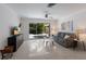Bright living room features terrazzo flooring, a ceiling fan, and sliding glass doors to the outdoor patio at 671 47Th St, Sarasota, FL 34234