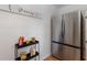 Clean pantry area with shelving and a stainless steel refrigerator with freezer drawers at 671 47Th St, Sarasota, FL 34234
