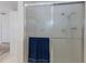 A bathroom shower with sliding doors and a blue towel at 671 47Th St, Sarasota, FL 34234