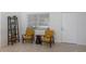 Inviting sitting area with two mid-century modern chairs and Terrazzo floors creating a cozy space at 671 47Th St, Sarasota, FL 34234