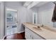 Bathroom with single vanity, toilet, and access to another room at 7242 Villa D Este Dr, Sarasota, FL 34238