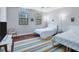 Guest bedroom with two twin beds and hardwood floors at 7242 Villa D Este Dr, Sarasota, FL 34238