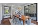 Bright dining room with wood table and chairs, view into Gathering room and patio at 7242 Villa D Este Dr, Sarasota, FL 34238