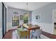 Bright dining room with hardwood floors, built-in bench seating, and large windows at 7242 Villa D Este Dr, Sarasota, FL 34238