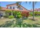 Well-maintained home exterior with manicured lawn and landscaping at 7242 Villa D Este Dr, Sarasota, FL 34238