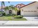 Exterior of charming house with lush landscaping, a two-car garage, and inviting entryway at 7242 Villa D Este Dr, Sarasota, FL 34238