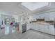 Modern white kitchen with stainless steel appliances and tile floors at 7242 Villa D Este Dr, Sarasota, FL 34238