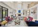 Open living area with hardwood floors, fireplace, and stylish mid-century modern furniture at 7242 Villa D Este Dr, Sarasota, FL 34238
