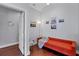Small office with orange couch and wood floors at 7242 Villa D Este Dr, Sarasota, FL 34238
