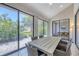 Bright sunroom with table and chairs, overlooking a lush patio at 7242 Villa D Este Dr, Sarasota, FL 34238