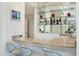 Wet bar with glass shelving, mirrored backsplash and seating for three at 7242 Villa D Este Dr, Sarasota, FL 34238