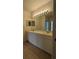 Clean bathroom with double vanity, mirror, and light fixture at 7307 Fountain Palm Cir # 7-102, Bradenton, FL 34203