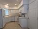 White kitchen features ample cabinetry, tile flooring, and appliances at 7307 Fountain Palm Cir # 7-102, Bradenton, FL 34203