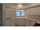 Kitchen with white cabinets, appliances, and a window overlooking patio at 7307 Fountain Palm Cir # 7-102, Bradenton, FL 34203