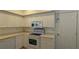 View of white kitchen with built-in microwave and electric range at 7307 Fountain Palm Cir # 7-102, Bradenton, FL 34203