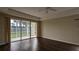Living room with dark laminate floors and sliding glass doors to backyard at 7307 Fountain Palm Cir # 7-102, Bradenton, FL 34203