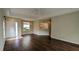 Spacious living room with dark laminate floors and neutral decor at 7307 Fountain Palm Cir # 7-102, Bradenton, FL 34203