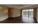 Living room with dark laminate floors and sliding glass doors to patio at 7307 Fountain Palm Cir # 7-102, Bradenton, FL 34203