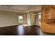 Living room with dark laminate floors, neutral walls, and access to kitchen at 7307 Fountain Palm Cir # 7-102, Bradenton, FL 34203