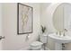 Stylish powder room with pedestal sink and art at 788 Sigsbee Loop, Sarasota, FL 34240