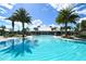 Resort-style pool with palm trees and a clubhouse in background at 788 Sigsbee Loop, Sarasota, FL 34240