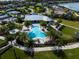 Community pool and tennis courts with palm trees at 788 Sigsbee Loop, Sarasota, FL 34240