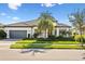 One-story home with green lawn and palm trees at 788 Sigsbee Loop, Sarasota, FL 34240