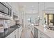 Open concept kitchen with stainless steel appliances and white cabinets at 788 Sigsbee Loop, Sarasota, FL 34240