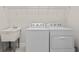 Bright laundry room with utility sink and storage at 788 Sigsbee Loop, Sarasota, FL 34240