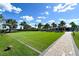 Community lawn area with artificial turf and a walkway at 788 Sigsbee Loop, Sarasota, FL 34240