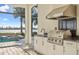 Outdoor kitchen with stainless steel appliances and water views at 788 Sigsbee Loop, Sarasota, FL 34240