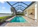 Inviting pool and spa with screened enclosure and lake views at 788 Sigsbee Loop, Sarasota, FL 34240