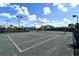 Two tennis courts with shade structure and surrounding landscape at 788 Sigsbee Loop, Sarasota, FL 34240