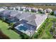 Aerial view of a home featuring a screened-in pool and backyard, with lush landscaping at 8367 Sea Glass Ct, Sarasota, FL 34240