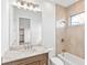 Well-lit bathroom featuring a vanity with marble countertop and tiled shower and tub at 8367 Sea Glass Ct, Sarasota, FL 34240