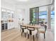 Dining area with seating near sliding glass doors and kitchen bar area at 8367 Sea Glass Ct, Sarasota, FL 34240
