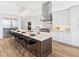 Modern kitchen featuring a large island with seating, custom cabinetry, and stainless steel appliances at 8367 Sea Glass Ct, Sarasota, FL 34240