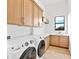 Bright laundry room with modern washer and dryer, and ample counter space at 8367 Sea Glass Ct, Sarasota, FL 34240