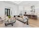 Bright living area with modern design elements, open access to the kitchen, and comfortable seating at 8367 Sea Glass Ct, Sarasota, FL 34240
