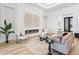 Comfortable living room with modern fireplace, stylish seating, and an open view of the foyer at 8367 Sea Glass Ct, Sarasota, FL 34240
