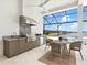 Outdoor kitchen and dining area overlooks the pool and a scenic lake view at 8367 Sea Glass Ct, Sarasota, FL 34240