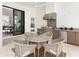 Outdoor kitchen area with stainless steel appliances, grill, and dining table on a patio at 8367 Sea Glass Ct, Sarasota, FL 34240