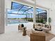 Spacious lanai with comfortable seating and views of the pool and tranquil lake at 8367 Sea Glass Ct, Sarasota, FL 34240