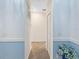 Hallway with light blue wainscoting and tile flooring at 8780 Coco Bay Blvd, Englewood, FL 34224