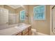 Clean bathroom with single sink vanity and shower/tub combo at 11705 Clubhouse Dr, Lakewood Ranch, FL 34202