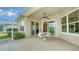 Covered patio with seating area, adjacent to pool and screened enclosure at 11705 Clubhouse Dr, Lakewood Ranch, FL 34202