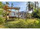Charming backyard oasis featuring a pergola and seating area at 118 24Th W St, Bradenton, FL 34205